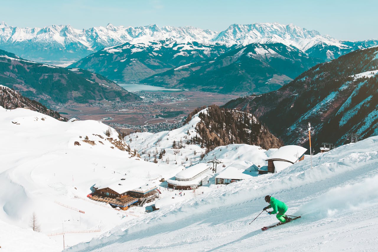 A skier enjoying the snowy slopes with stunning views of the Kaprun Alps in Austria.